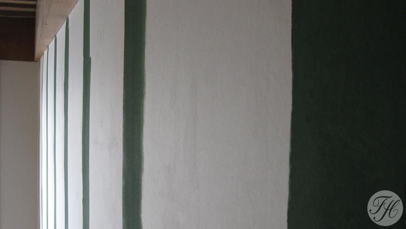 Aanbrengen van banen verf op betengeling als voorbewerking voor het behangen met een donker gekleurde behangsoort